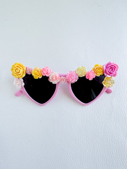 a pair of sunglasses with flowers on them