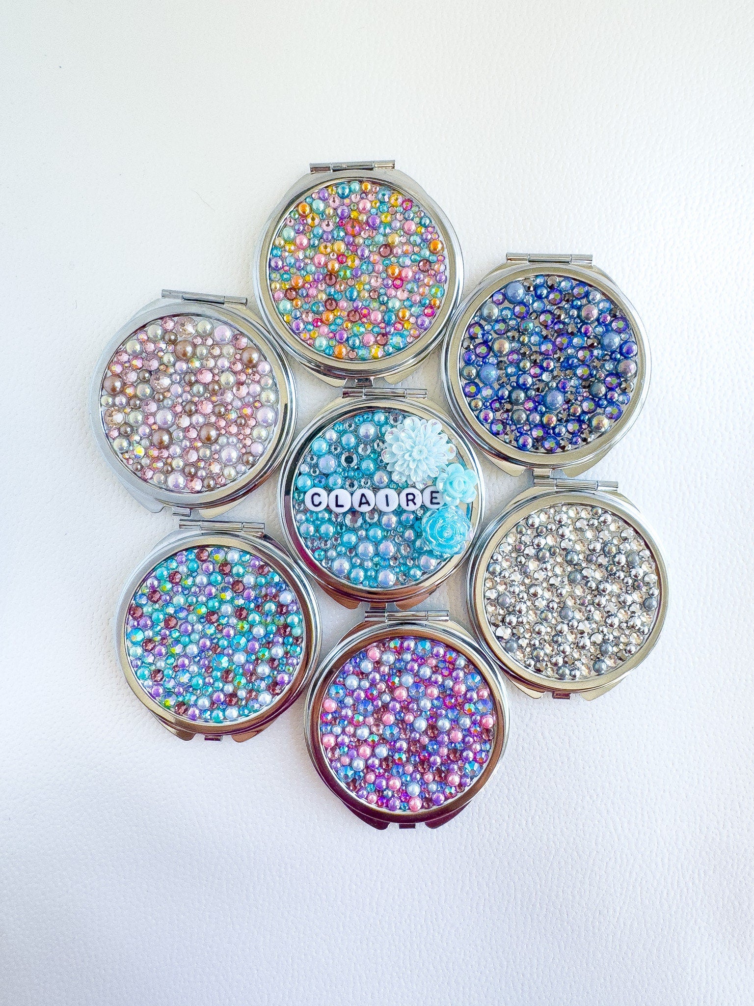 a set of six containers filled with lots of different colored beads