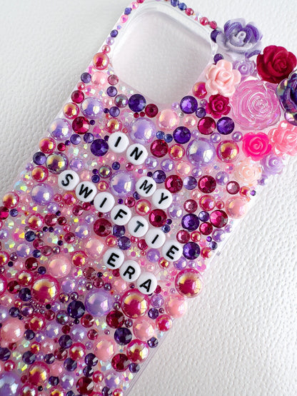 a cell phone case with a scrabble of beads and flowers on it