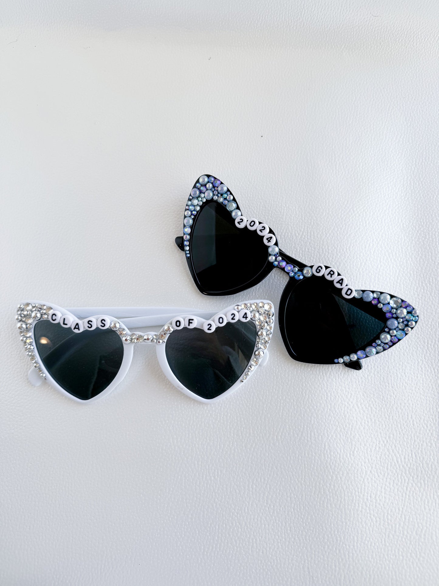 a pair of black and white sunglasses on a white surface