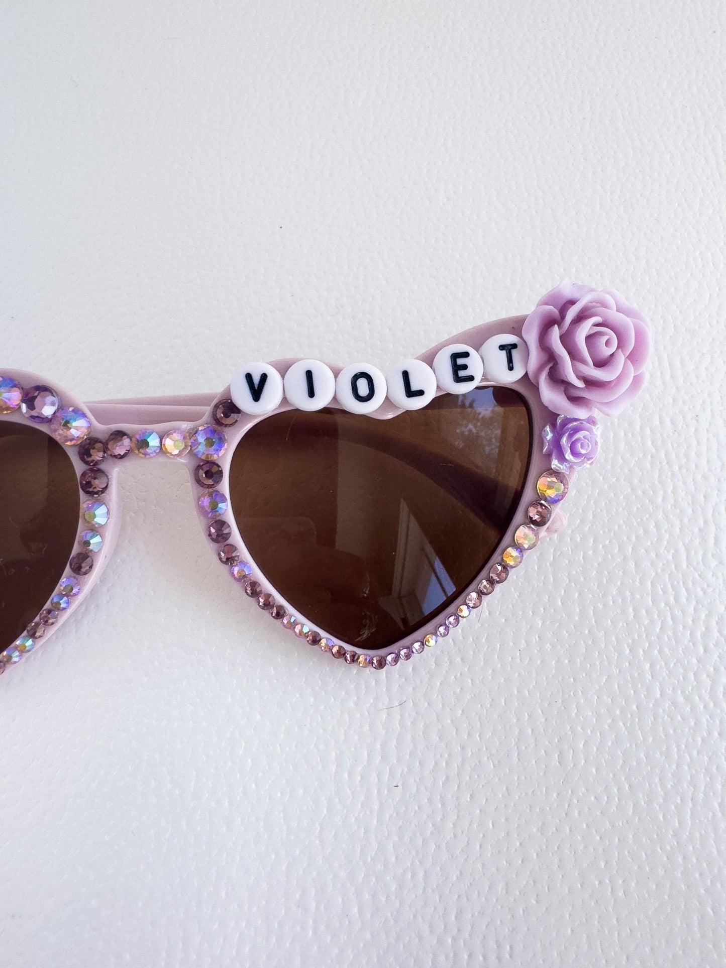 a pair of sunglasses with the word violet written on them