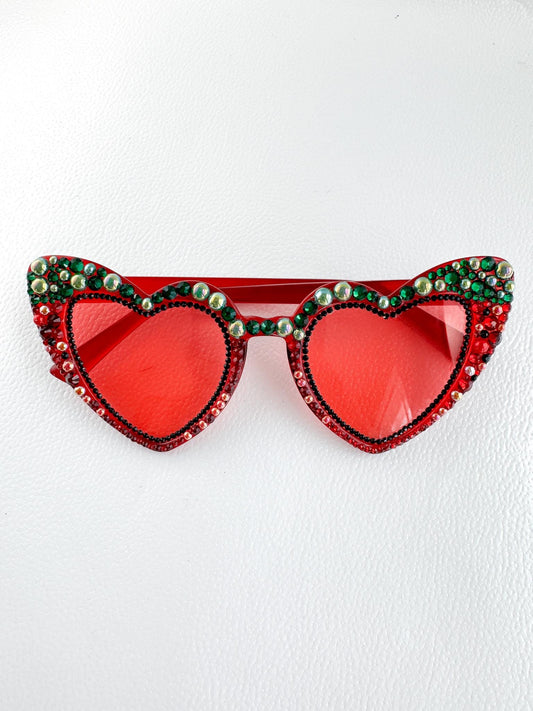 a pair of red sunglasses with a heart shaped frame