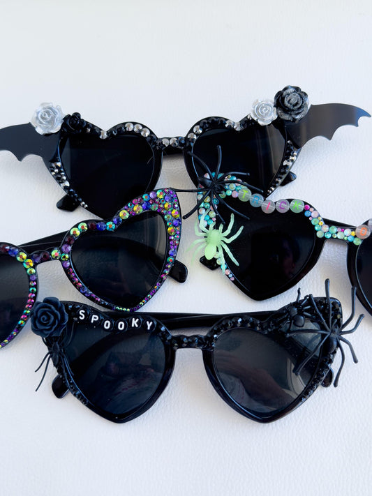 a group of sunglasses with a spider on them