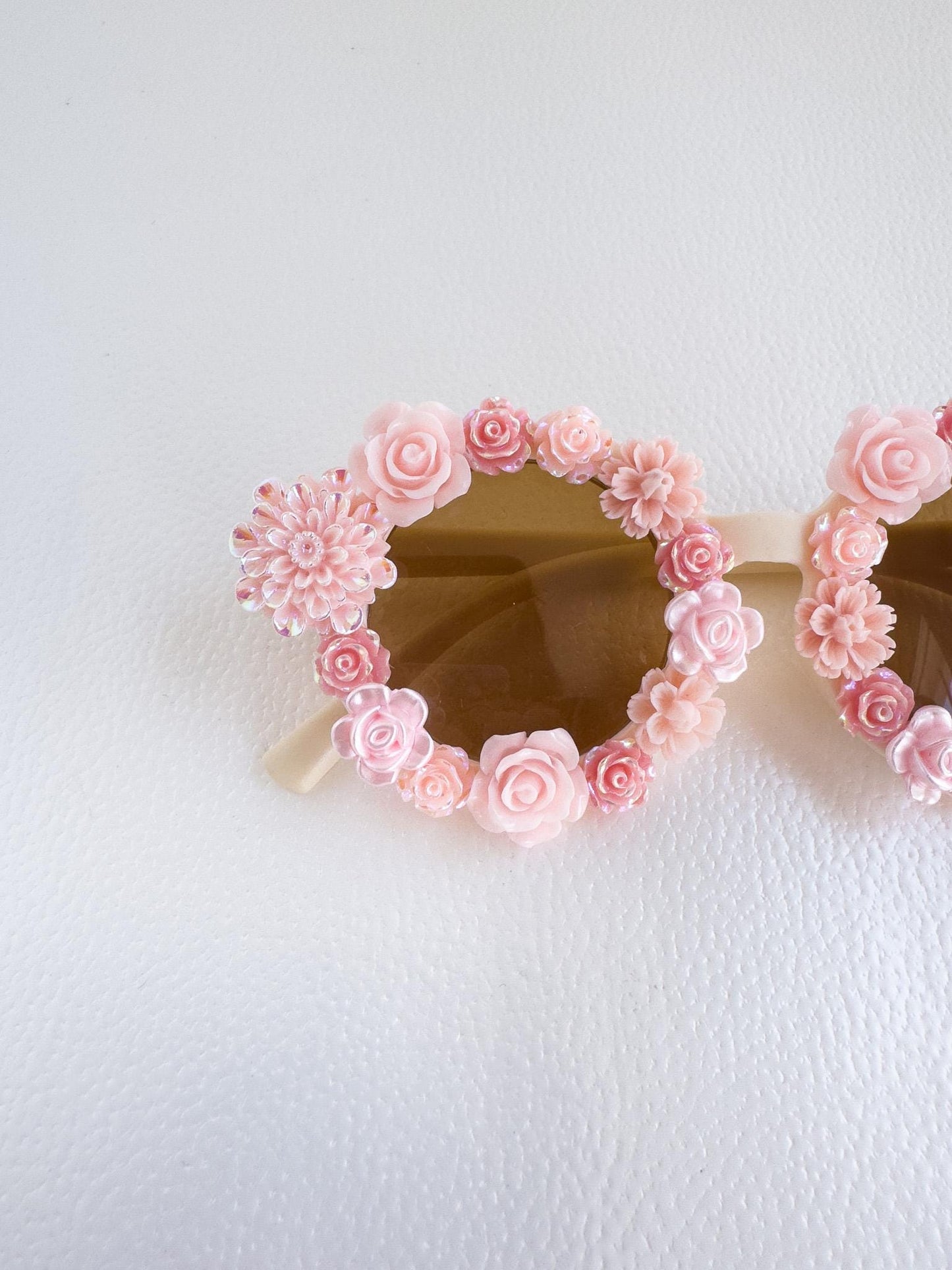 a pair of sunglasses with pink flowers on them