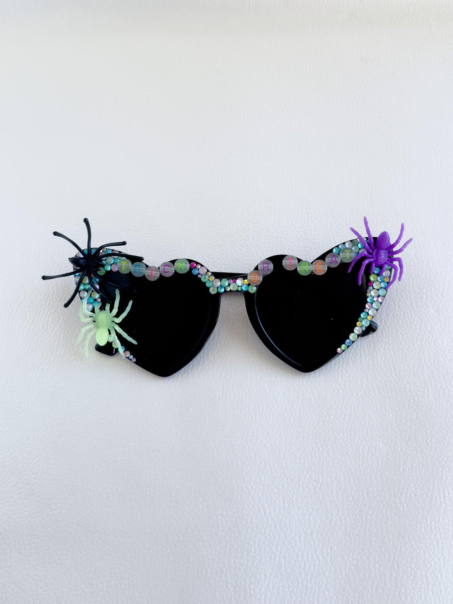 a pair of sunglasses with spider decorations on them