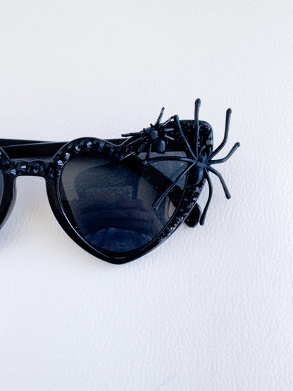 a pair of sunglasses with a spider on the side